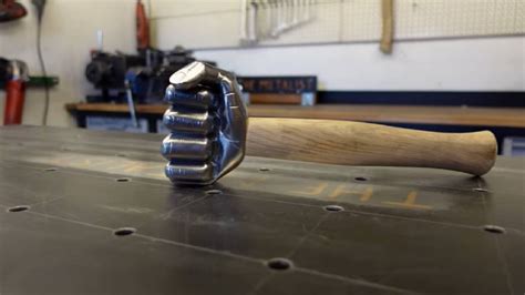 kid hammers metal box into fist|Video Demonstrates How to Turn an Old Hammer Into an Iron Fist.